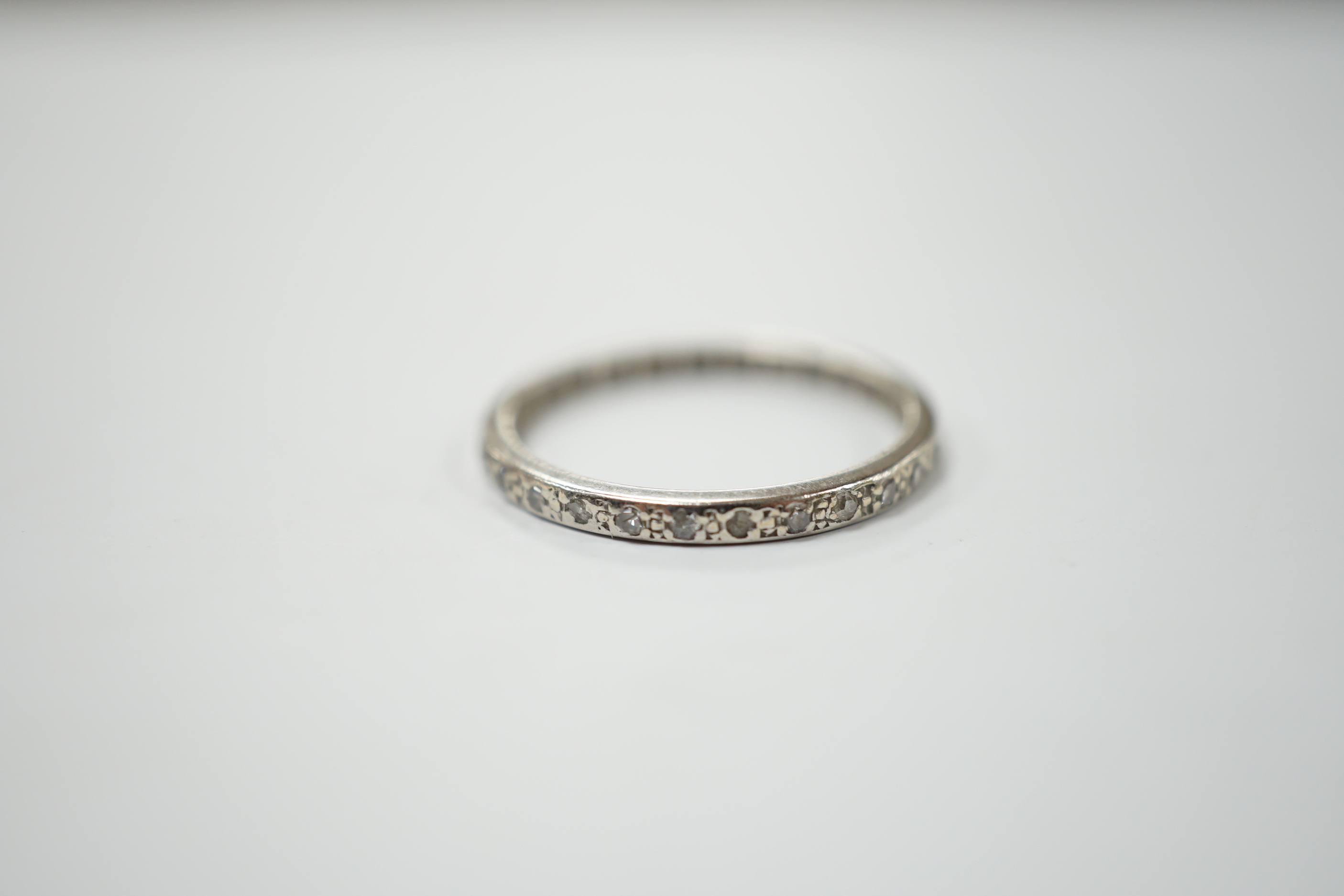 An early 20th century white metal diamond set full eternity ring, size O